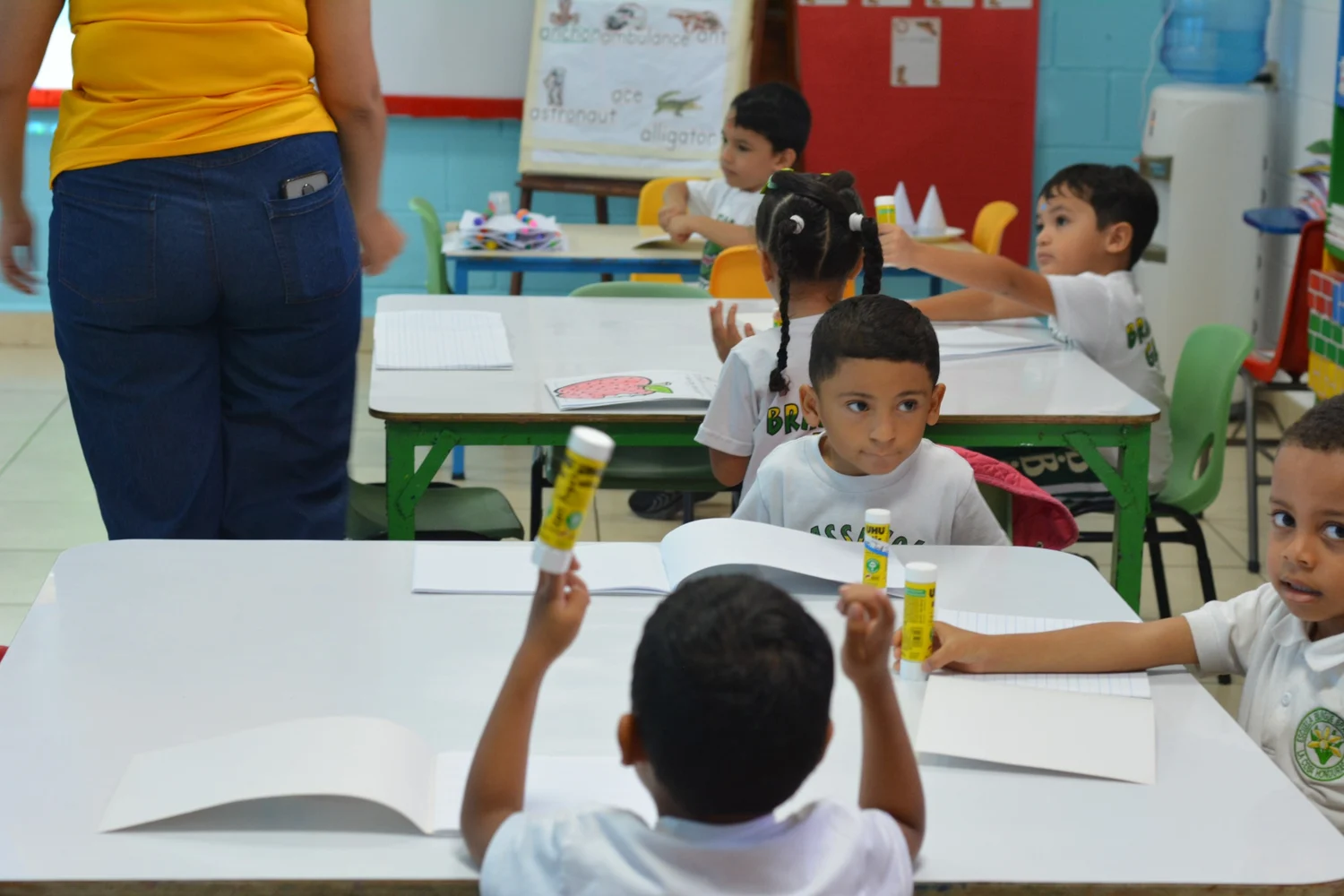 Teacher supporting Brassavola students in their learning